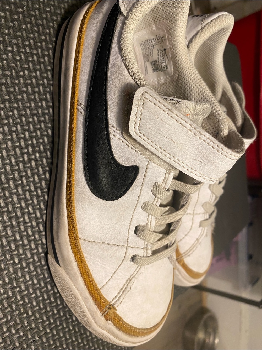 Nike Kids White Sneakers with Black Swoosh and Gold Trim